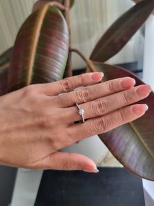 Engagement Ring with a Center Round White Diamond and Round White Diamond Side Stones | Fête Matrimony XXVI